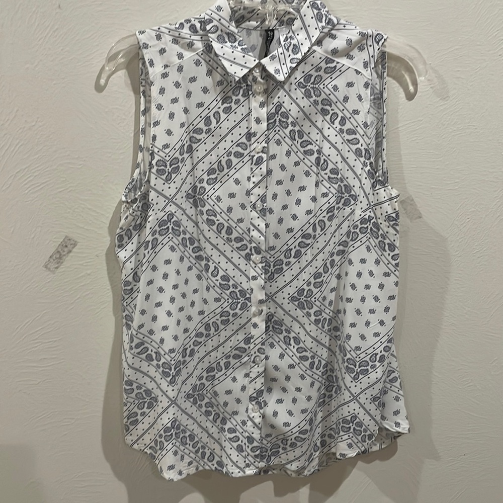 White and navy print sleeveless blouse.